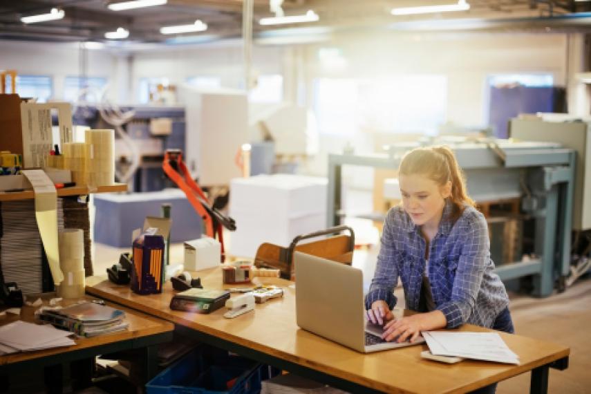 woman in warehouse on computer