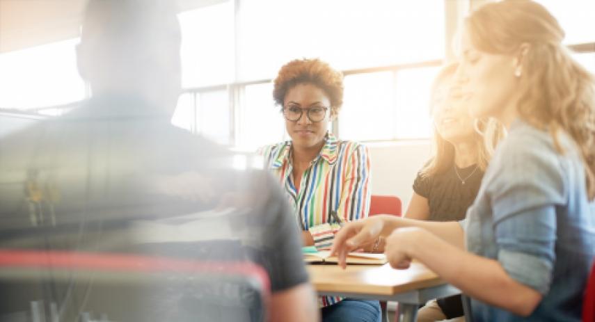 Woman listening to colleague in meeting